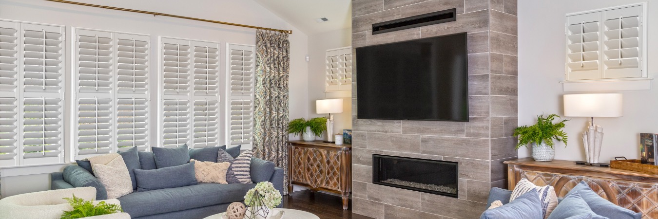 Interior shutters in Riverview family room with fireplace