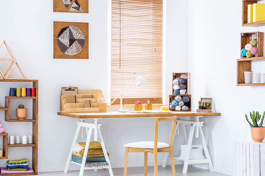 Wood blinds in a white and airy craft corner.
